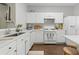 Modern kitchen with white cabinets, countertops, and stainless appliances at 3754 Berkeley Xing, Duluth, GA 30096