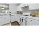 Modern kitchen with white cabinets, counters, and stainless steel appliances at 3754 Berkeley Xing, Duluth, GA 30096