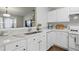 Bright kitchen features white cabinetry, countertops, stainless steel sink, and modern appliances at 3754 Berkeley Xing, Duluth, GA 30096
