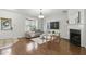 Inviting living room featuring a bay window, fireplace, and modern decor at 3754 Berkeley Xing, Duluth, GA 30096