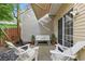 Inviting patio featuring white furniture, awning, and sliding glass door, perfect for outdoor relaxation and entertaining at 3754 Berkeley Xing, Duluth, GA 30096