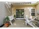 Relaxing patio with white furniture, awning, and sliding door access, ideal for enjoying the outdoors at 3754 Berkeley Xing, Duluth, GA 30096