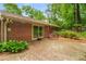 Back patio featuring brick and a wooden bench, accessible through sliding glass doors at 2556 Defoors Ferry Nw Rd, Atlanta, GA 30318