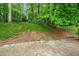A sloped backyard featuring a lush, treed view at 2556 Defoors Ferry Nw Rd, Atlanta, GA 30318