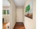 Welcoming hallway with hardwood floors, leading to a bright room with a view, and stylishly decorated with tree art at 2556 Defoors Ferry Nw Rd, Atlanta, GA 30318