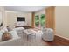 Bright living room featuring hardwood floors, modern furniture, and sliding glass doors leading to outdoor greenery at 2556 Defoors Ferry Nw Rd, Atlanta, GA 30318