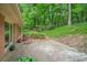 Brick patio, bench and natural landscaping in the backyard at 2559 Defoors Ferry Nw Rd, Atlanta, GA 30318