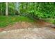 This backyard features natural landscaping and a brick patio at 2559 Defoors Ferry Nw Rd, Atlanta, GA 30318