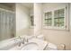 Bathroom with white tile and granite countertop at 2559 Defoors Ferry Nw Rd, Atlanta, GA 30318