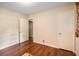 Bedroom with hardwood floors, neutral walls, and two closets at 2559 Defoors Ferry Nw Rd, Atlanta, GA 30318