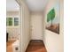 Bright hallway with hardwood floors, an entry door, and decorative wall art at 2559 Defoors Ferry Nw Rd, Atlanta, GA 30318