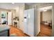 Bright kitchen with a refrigerator, desk area, and wood floors at 2559 Defoors Ferry Nw Rd, Atlanta, GA 30318