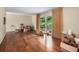 Spacious living room with hardwood floors and natural light filtering through the back door at 2559 Defoors Ferry Nw Rd, Atlanta, GA 30318