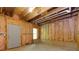 Unfinished basement space displaying insulation, concrete flooring, and a utility door, ready for customization at 3260 Ridgefair Dr, Cumming, GA 30040