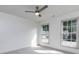 Well-lit bedroom featuring neutral walls, carpet, and ceiling fan, complemented by natural light through two windows at 3260 Ridgefair Dr, Cumming, GA 30040