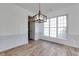 Dining room with wood-look flooring, chair rail, and a modern, dark, wrought-iron chandelier at 3260 Ridgefair Dr, Cumming, GA 30040