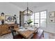 Dining room featuring wood table and decor; well-lit by window and modern chandelier at 3260 Ridgefair Dr, Cumming, GA 30040