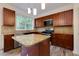 Kitchen with dark wood cabinets, granite countertops, stainless steel appliances, and a center island at 3260 Ridgefair Dr, Cumming, GA 30040