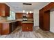 Spacious kitchen with island, stainless steel appliances, granite countertops, and wood-look floors at 3260 Ridgefair Dr, Cumming, GA 30040