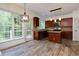 Eat-in kitchen featuring wood-look flooring, island, and access to backyard porch at 3260 Ridgefair Dr, Cumming, GA 30040