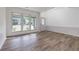 Sun-drenched living room with wood-look flooring, neutral walls, chair rail, and light-filled windows at 3260 Ridgefair Dr, Cumming, GA 30040