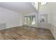 Open concept living room with wood-look floors, chair rail, and a window-filled front entrance at 3260 Ridgefair Dr, Cumming, GA 30040