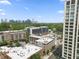 Aerial view of the neighborhood, showing the apartment building in relation to the greenery and Atlanta skyline at 660 Glen Iris Dr # 206 & 109, Atlanta, GA 30308