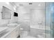 Bright bathroom with marble tiling, dual sinks, and a glass-enclosed shower at 660 Glen Iris Dr # 206 & 109, Atlanta, GA 30308
