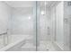 Bathroom featuring marble tiling, a soaking tub, and glass-enclosed shower at 660 Glen Iris Dr # 206 & 109, Atlanta, GA 30308