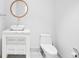 A sleek bathroom features modern fixtures, a floating vanity, and a round mirror at 660 Glen Iris Dr # 206 & 109, Atlanta, GA 30308