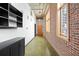 Hallway with exposed brick, overhead lighting, and modern shelving, creating an industrial aesthetic at 660 Glen Iris Dr # 206 & 109, Atlanta, GA 30308