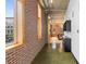 Hallway featuring exposed brick, sleek overhead lighting, and contemporary shelving at 660 Glen Iris Dr # 206 & 109, Atlanta, GA 30308