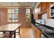 Charming kitchen with wood cabinets, stainless appliances, and black countertops at 660 Glen Iris Dr # 206 & 109, Atlanta, GA 30308