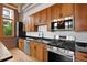 Charming kitchen with wood cabinets, stainless appliances, and black countertops at 660 Glen Iris Dr # 206 & 109, Atlanta, GA 30308