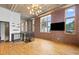 Bright living area features exposed brick, wood floors, and modern lighting fixture at 660 Glen Iris Dr # 206 & 109, Atlanta, GA 30308