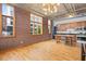 Bright living room with hardwood floors, brick walls, and an open kitchen area at 660 Glen Iris Dr # 206 & 109, Atlanta, GA 30308