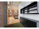 Open-concept living area with hardwood floors, exposed brick, and custom shelving at 660 Glen Iris Dr # 206 & 109, Atlanta, GA 30308