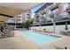 Resort-style pool with many chairs, tables, and umbrellas with residential buildings at 660 Glen Iris Dr # 206 & 109, Atlanta, GA 30308