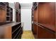 Walk-in closet with wood shelving, custom cabinets, and open storage spaces at 660 Glen Iris Dr # 206 & 109, Atlanta, GA 30308