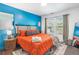Stylish bedroom with bright blue accent wall, large window, and unique decor at 999 Washington Sw St, Atlanta, GA 30315
