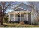 Charming home featuring a welcoming front porch with white pillars and a well-maintained lawn at 999 Washington Sw St, Atlanta, GA 30315