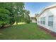Lush backyard featuring a well-manicured lawn and a view of the house with ample natural light at 1001 Wiley Bridge Rd, Woodstock, GA 30188