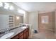 Spacious bathroom with a double granite vanity, tile floors, and a bright window at 1001 Wiley Bridge Rd, Woodstock, GA 30188