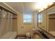 Full basement bathroom features a shower/tub combo, marble vanity, and tiled floor at 1001 Wiley Bridge Rd, Woodstock, GA 30188