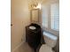 Cozy bathroom featuring a stylish vanity with dark wood and a framed mirror at 1001 Wiley Bridge Rd, Woodstock, GA 30188