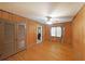 Cozy bedroom featuring wood paneling, hardwood floors, and ample closet space at 1001 Wiley Bridge Rd, Woodstock, GA 30188