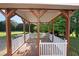 Charming gazebo with a wooden deck and white railings, perfect for outdoor relaxation at 1001 Wiley Bridge Rd, Woodstock, GA 30188