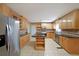 Open kitchen with stainless steel refrigerator, granite countertops, and tile flooring at 1001 Wiley Bridge Rd, Woodstock, GA 30188
