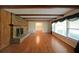 Spacious living room with hardwood floors, brick fireplace, wood beams, and large windows at 1001 Wiley Bridge Rd, Woodstock, GA 30188