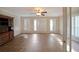 Bright living room with neutral walls, shutters, and tile flooring, offering ample natural light at 1001 Wiley Bridge Rd, Woodstock, GA 30188
